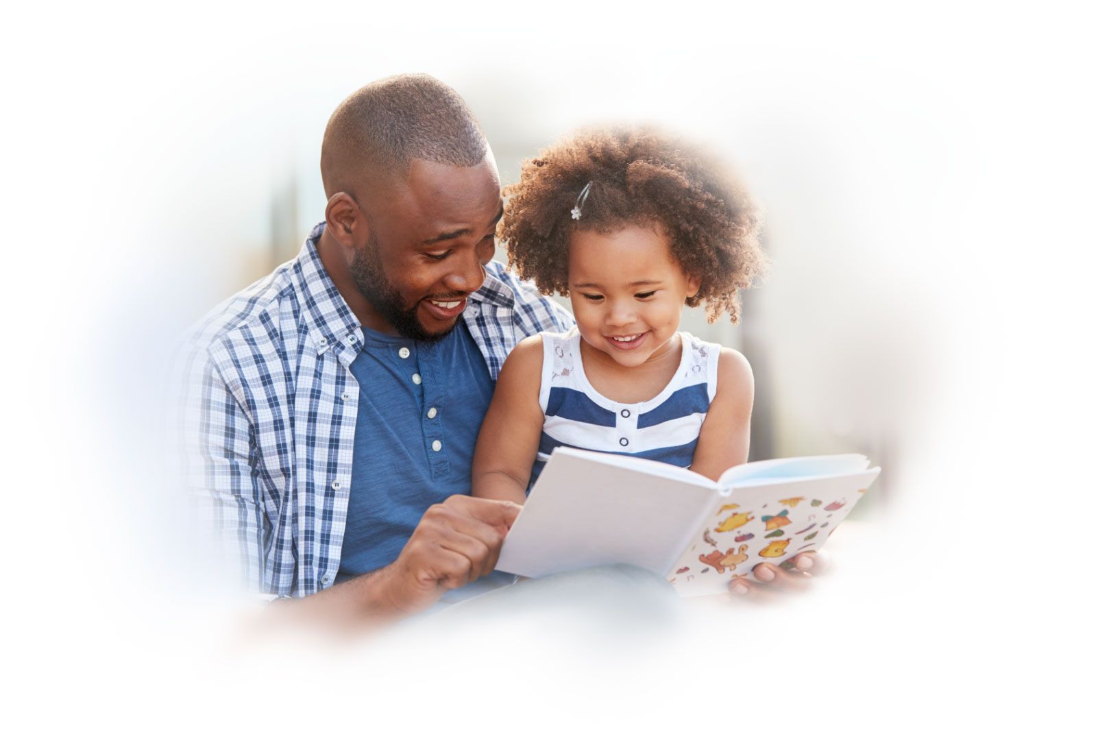 A father reads to his daughter