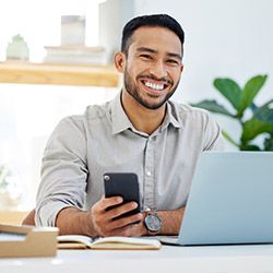 Hispanic sales rep working at his desk.