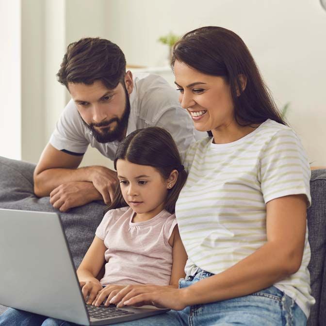 A family uses a laptop to pay student loan bills