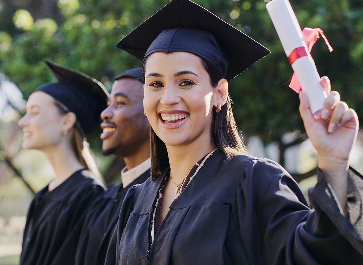 College or academy class graduate group in an outdoor campus portrait