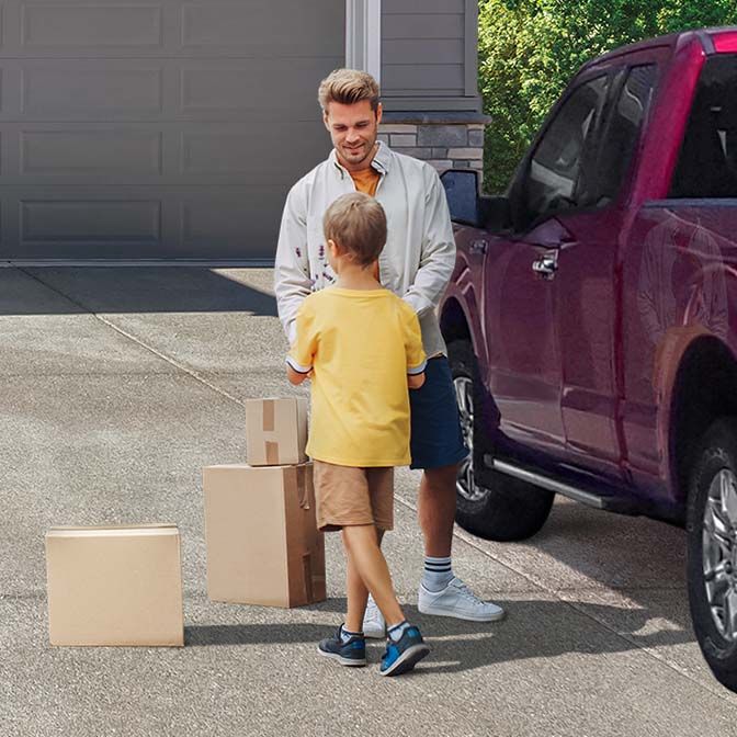 A father and son move boxes back home after a devastating natural disaster