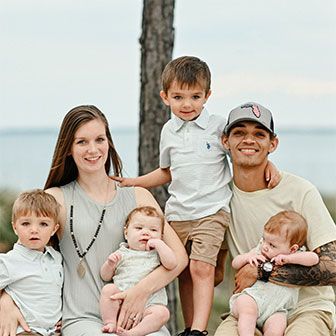 A happy family sitting together by the waterfront.