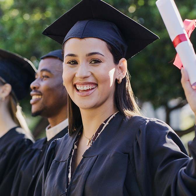 College or academy class graduate group in an outdoor campus portrait