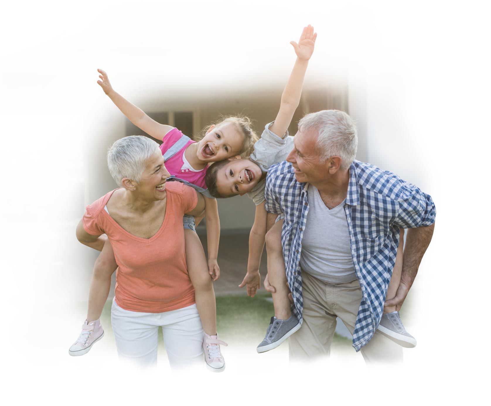 Happy grandparents playfully roughhouse with their young grandchildren