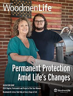 A Mother stands with her son in front of their house.