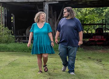 A Mother walking with her son at their farm.