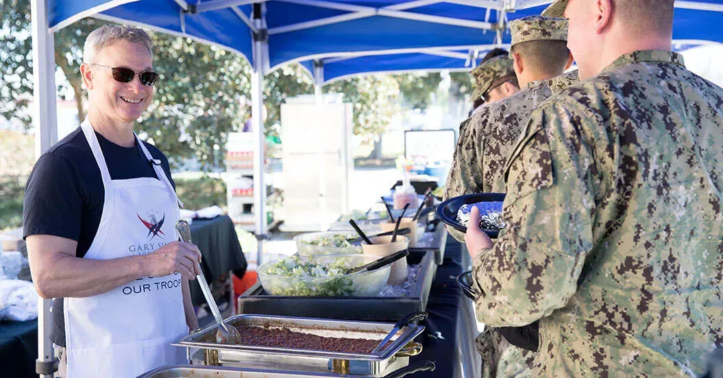 Gary Sinise serves beans to America's troops