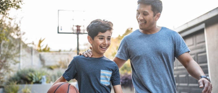 A father and son playing basketball